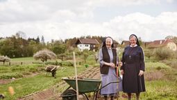 On Trafalgar’s Switzerland and Austria trip, guests chat with the Missionary Sisters of the Monastery of Kloster Wernberg, in Austria over an authentic Carinthian dinner, a Be My Guest experience.
